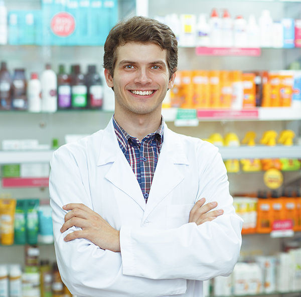 male pharmacist smiling in a pharmacy