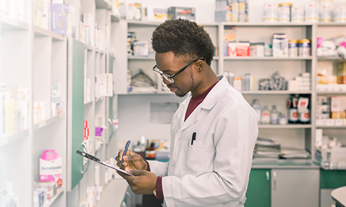 male pharmacist checking inventory