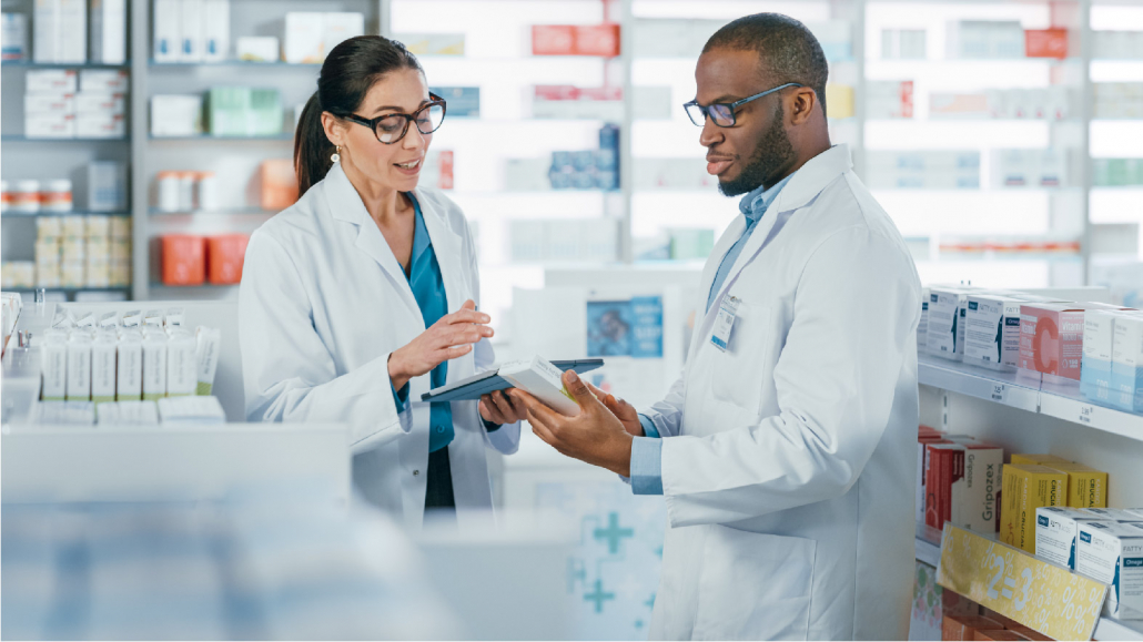 Two pharmacists reviewing a prescription, credentialing and compliance