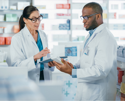 Two pharmacists reviewing a prescription, credentialing and compliance