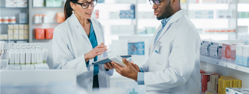 Two pharmacists reviewing a prescription, credentialing and compliance